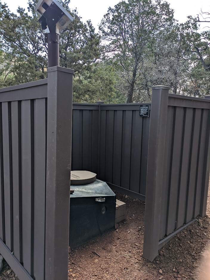 A partially enclosed composting toilet.